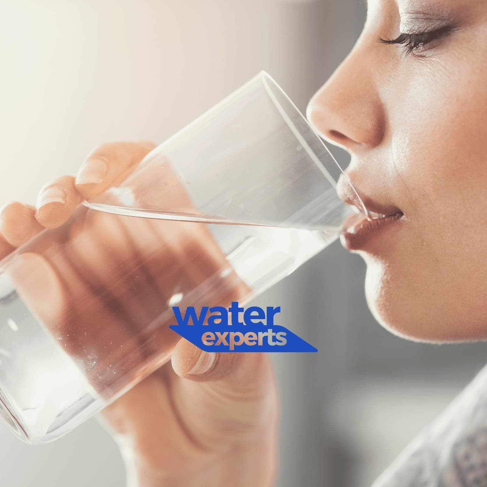 Water Experts - A woman enjoying a glass of pure mineral water