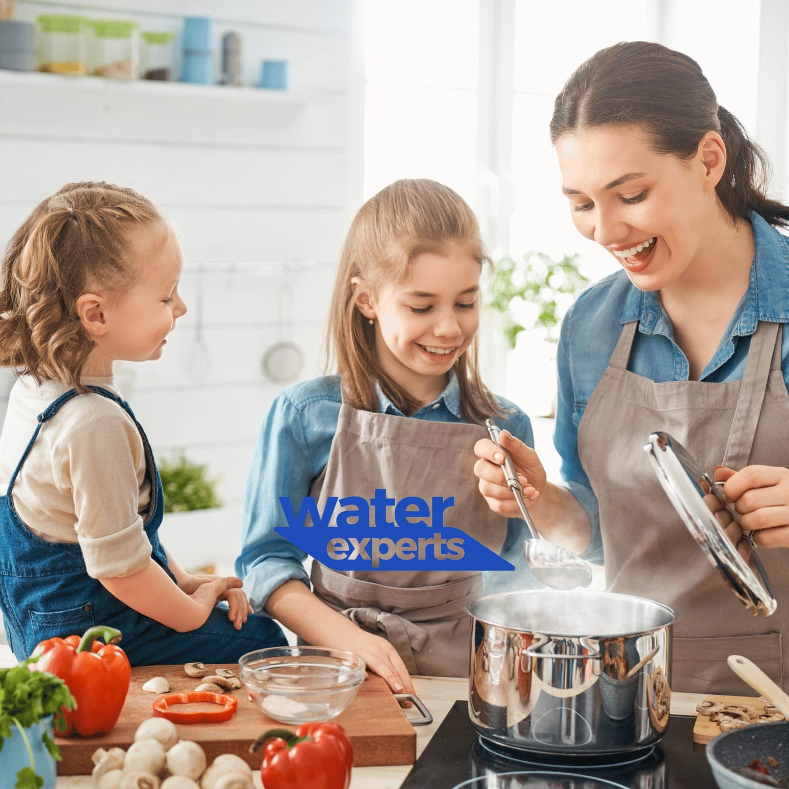 Mother cooking with her daughters using clean water.