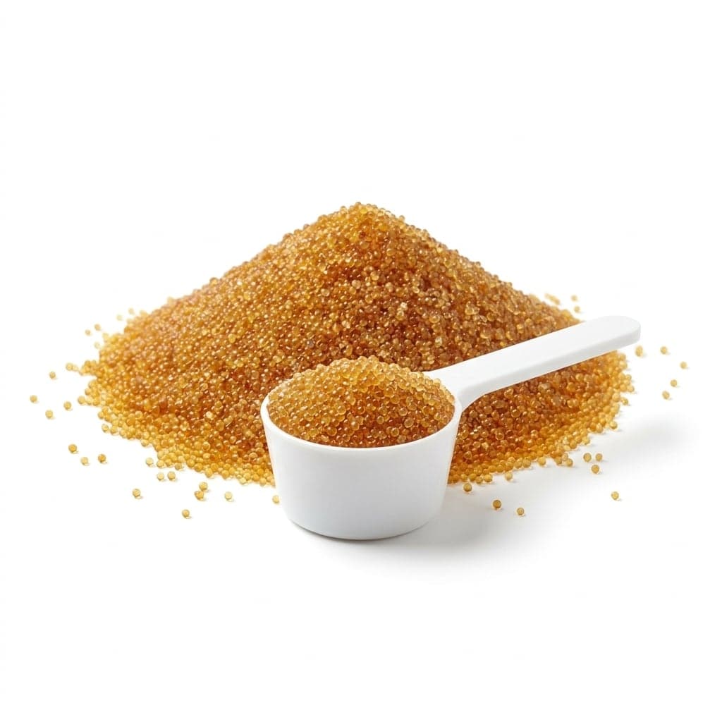 Heap and scoop of amber softener resin beads
