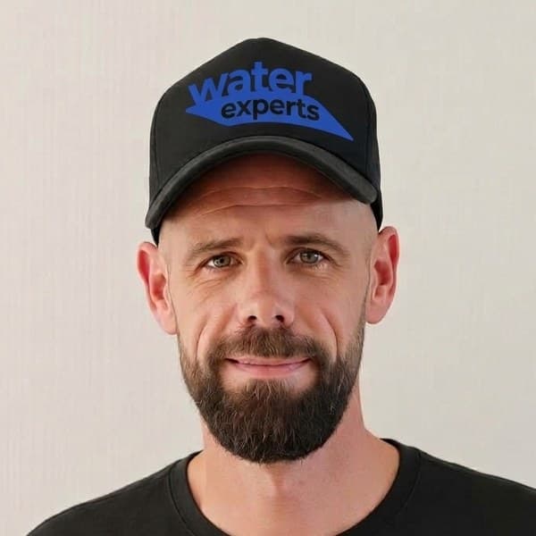 Dustin Koopmans, Master Plumber, in a Water Experts cap