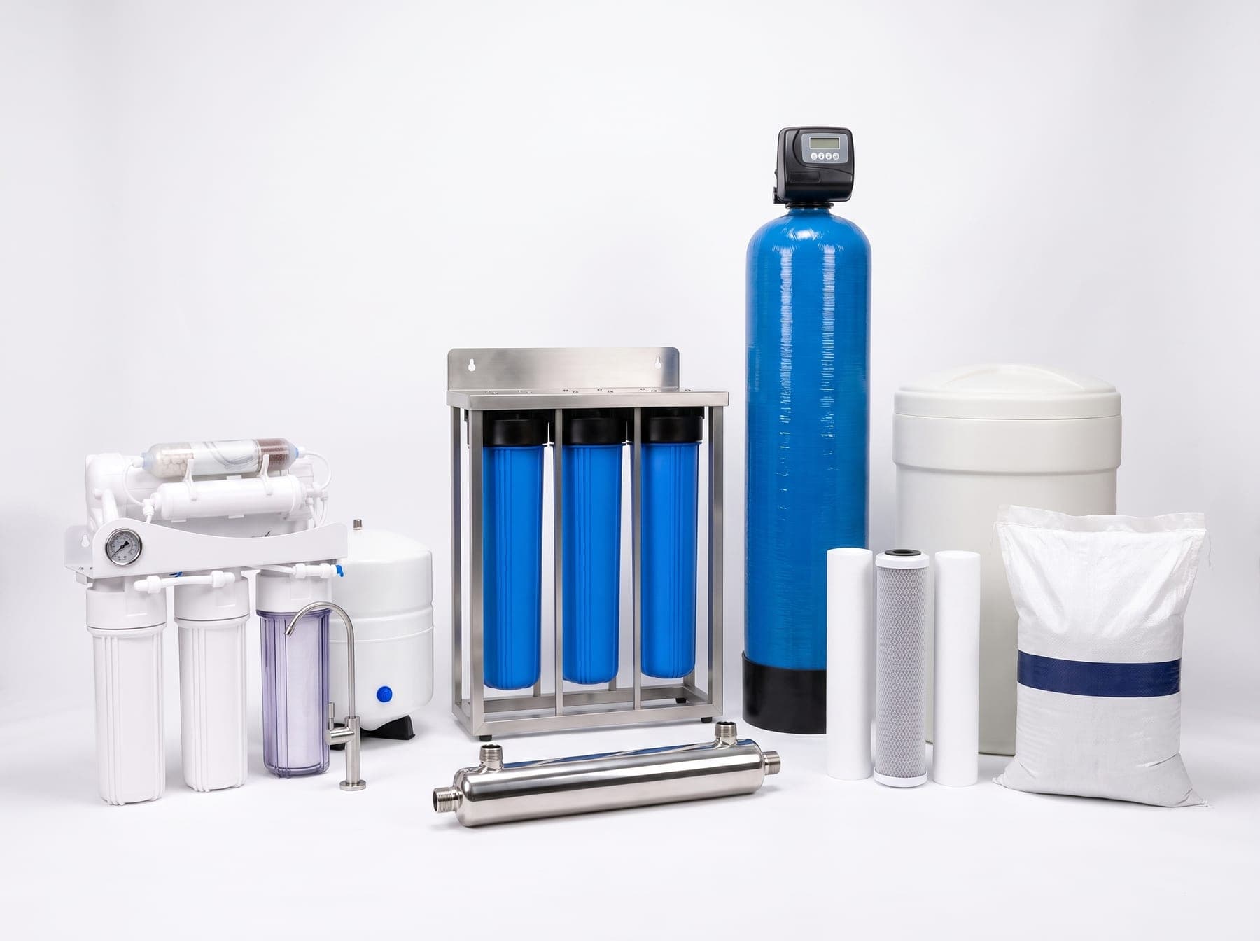 The Water Experts range: AquaShield purifier, AquaGuard whole-house unit, UV steriliser, FRP vessel with valve, brine tank, cartridges and filter media