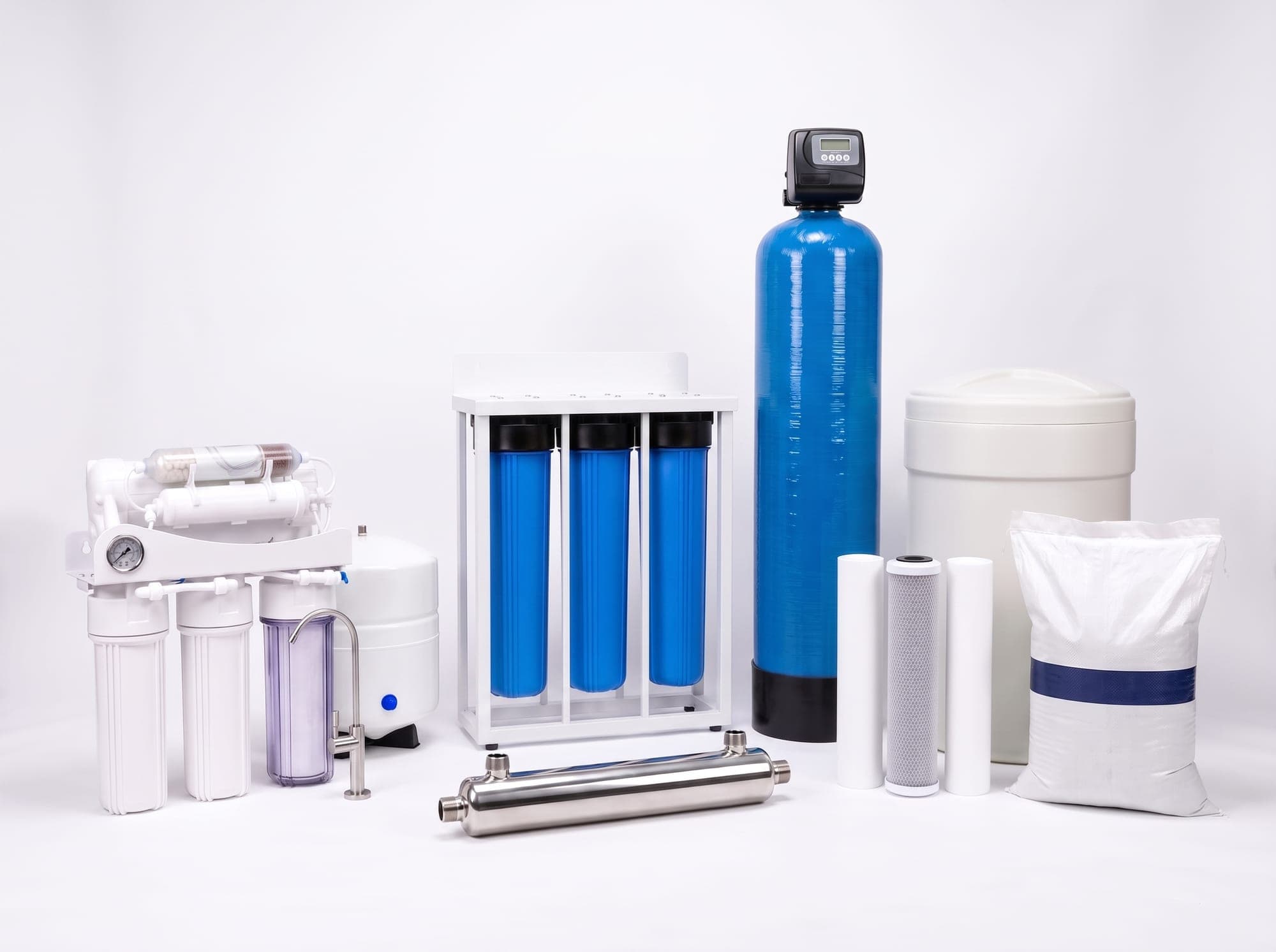 The Water Experts range: AquaShield purifier, AquaGuard whole-house unit, UV steriliser, FRP vessel with valve, brine tank, cartridges and filter media
